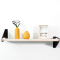 Front view of wooden shelf with geometric metal brackets
