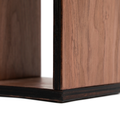 Close-up of a dark walnut veneer toilet paper holder with smooth wood grain texture and stained edges. The layered birch plywood construction is visible, highlighting its craftsmanship.