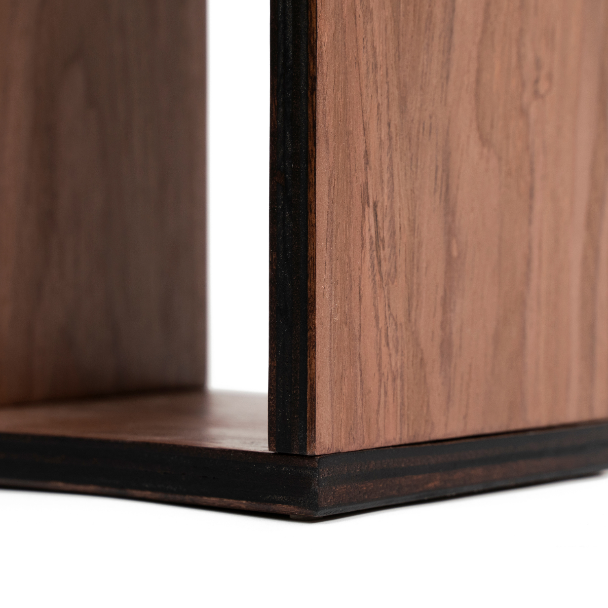 Close-up of a dark walnut veneer toilet paper holder with smooth wood grain texture and stained edges. The layered birch plywood construction is visible, highlighting its craftsmanship.