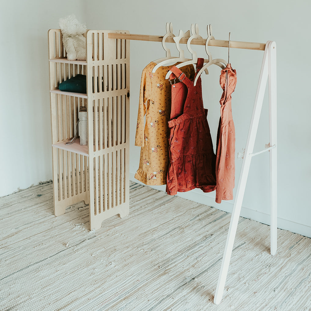 Wooden wardrobe with storage space and hangers for children