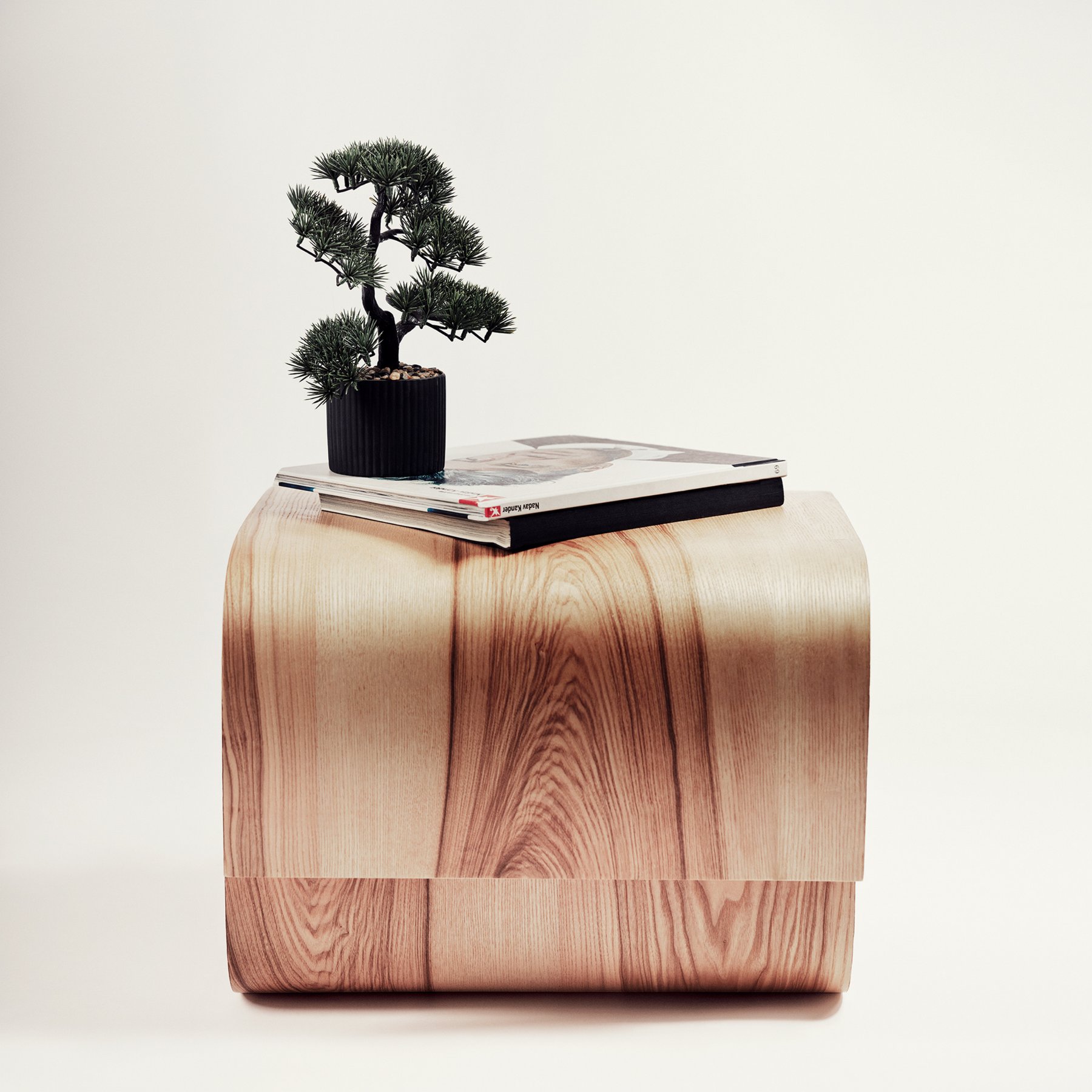 Side view of small round living room coffee table from wood with modern design