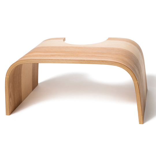 Toddler bathroom step stool made of curved plywood with a natural wood finish and U-shaped cutout