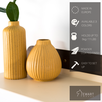 Floating metal shelf with golden screws and manufacturer specifics