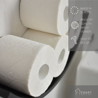 Close-up of three toilet paper rolls displayed on a curved wooden holder. The image includes text highlighting that the product is made in Europe, made of quality birch veneer, and easy to set up. The EWART WOODS logo is visible.