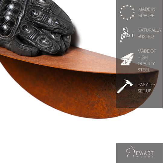 Rusted metal wall shelf featuring a gloved hand resting on it, emphasizing its durability, high-quality steel construction, and naturally weathered finish. Made in Europe with easy installation.