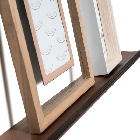 Picture frame placement on curved picture ledge shelf 