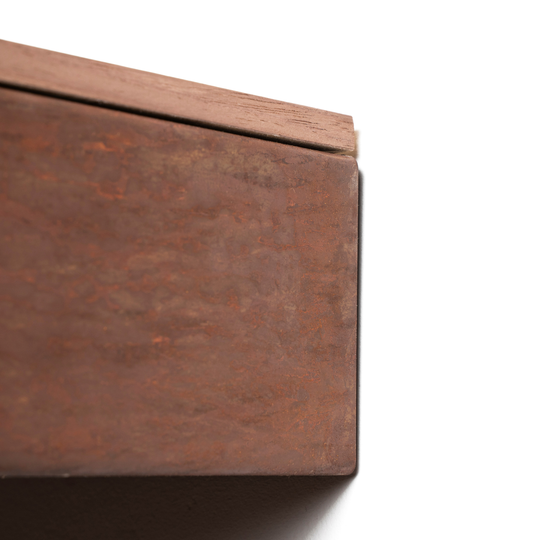 Close-up view of wall mounted rusted metal nightstand with wooden surface