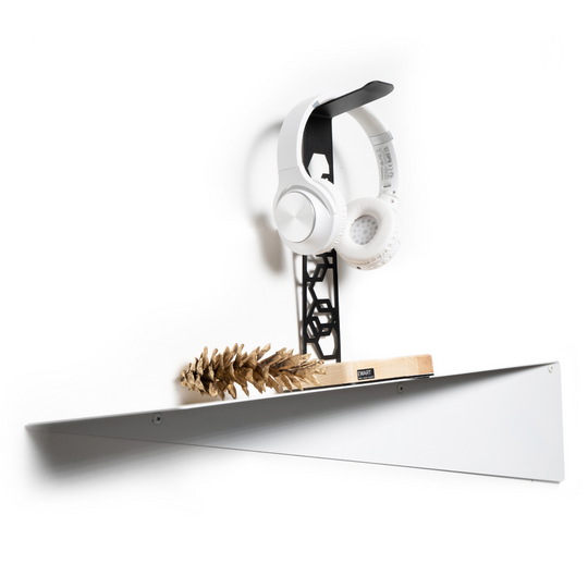 Triangular wall shelf featuring a headphone stand, a small wooden base, and a decorative pinecone, showcasing a blend of utility and aesthetic simplicity.