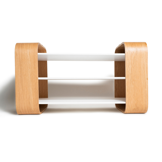 Clear front view of wooden coffee table with white shelves and brass accent on top