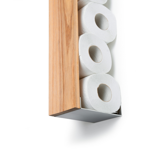 Vertical ashwood toilet paper holder with stainless steel base, holding multiple rolls of toilet paper, mounted on a wall