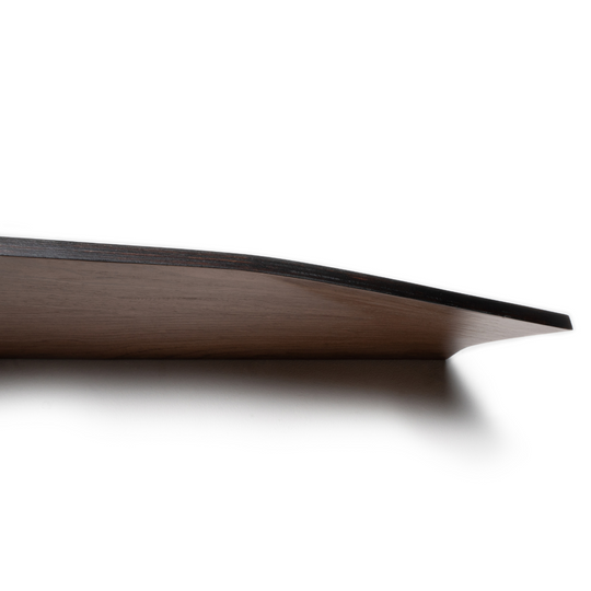 Side view of a wooden shelf with a curved edge and a dark, stained free edge. The angle emphasizes the shelf&