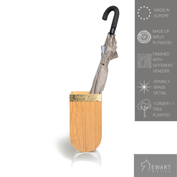 Wooden standing umbrella holder with brass edge design and white curved metal leg along manufacturer specifics 