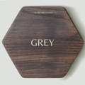 Hexagonal wooden key holder with a natural wood grain pattern, labeled &