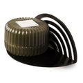 Modern, semicircular black metal shelf with a matte finish and a striped, arched back, holding a ribbed dark green container.