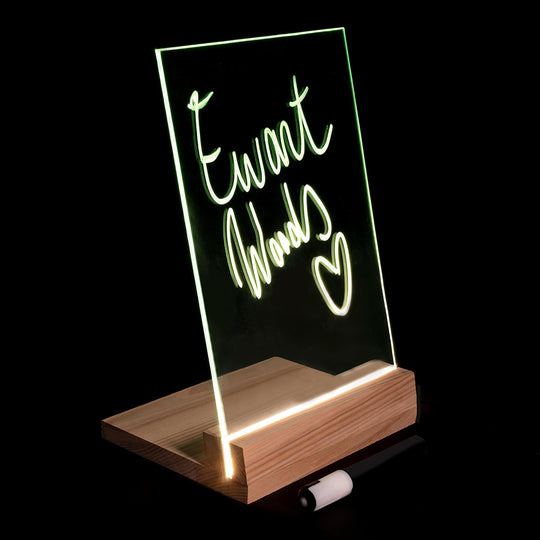 Light Glowing glass panel mounted on a wooden base, displaying the handwritten text &