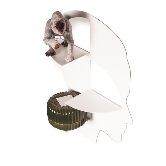 Silhouette-shaped wall shelf featuring a decorative monkey figurine on the top shelf and a green textured object on the middle shelf, highlighting its aesthetic and functional use.