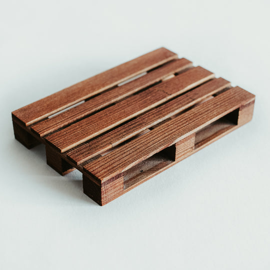 Handmade wooden pallet coaster in a rich brown stain, showcasing a smooth, polished texture and detailed craftsmanship, displayed on a white surface.