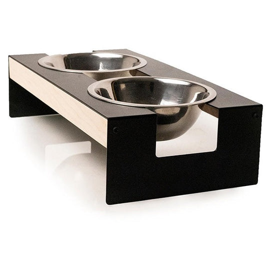 Elevated dog bowl stand featuring a sleek metal frame with wooden side panels, holding two stainless steel bowls securely in the metal top.