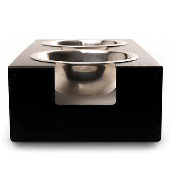 Front view of an elevated dog feeder featuring a minimalist black metal frame, housing two stainless steel bowls in a modern, square design.