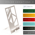 A sleek metal phone holder with a white geometric cutout design, displayed alongside a list of available color options: white, green, yellow, red, blue, black, and untreated metal.