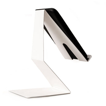 Side view of a sleek, Z-shaped white phone stand holding a smartphone at a slight angle, showcasing the stand's minimalist design with a flat base and curved support.