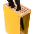 Yellow knife block with a wooden top, holding black-handled knives. The side of the block features a slot for additional knife storage, and the block is displayed against a white background.