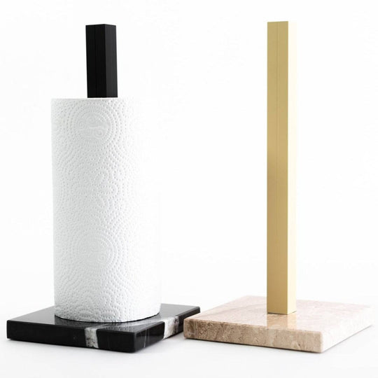 Elegant paper towel holders featuring a marble base and metal stand, available in black with white marble accents and gold with beige marble, combining functionality with modern design.