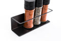 Spice rack with a black metal frame, neatly holding three spice jars in a compact, functional design.