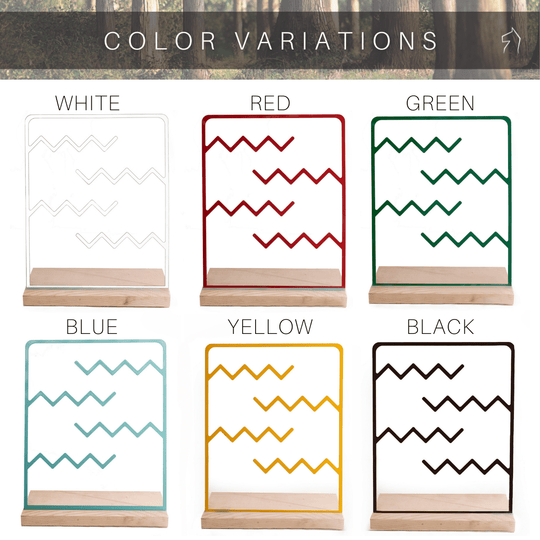 Jewelry holder available in six colors: white, red, green, blue, yellow, and black, featuring a zigzag metal design on a wooden base.