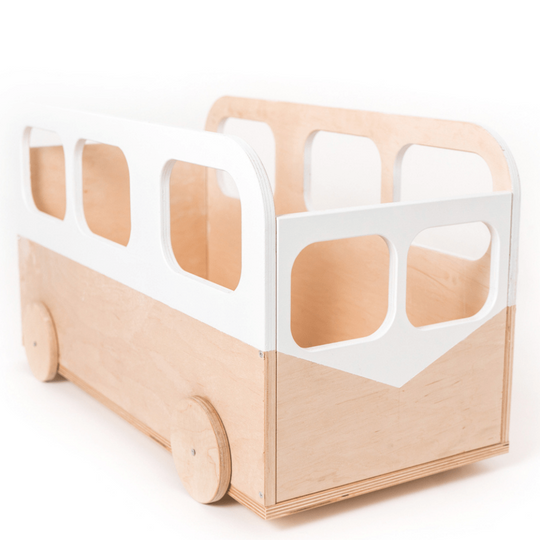 A wooden toy bus with a minimalist design, featuring round wheels and white cutout windows on its sides. The bus has an open top and smooth edges, suitable for children&