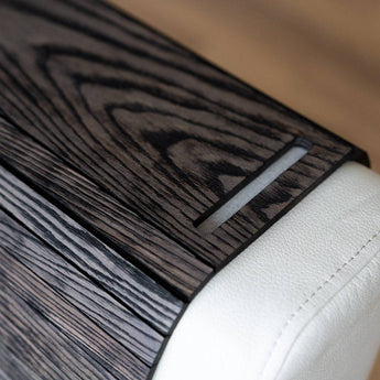 Burned Wooden Sofa Arm Tray Table on a couch arm, showcasing its versatility and stylish burnt wood finish. EWART WOODS