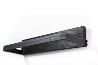 Modern black metal towel rack with a dark wood base, featuring a clean and geometric design.