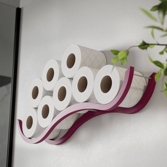 Wall-mounted wooden organizer with a wave design, neatly storing multiple toilet paper rolls, complemented by green plant leaves in the background.